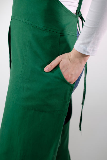 Close-up of chest pocket and stitching on artisan jumpsuit apron.