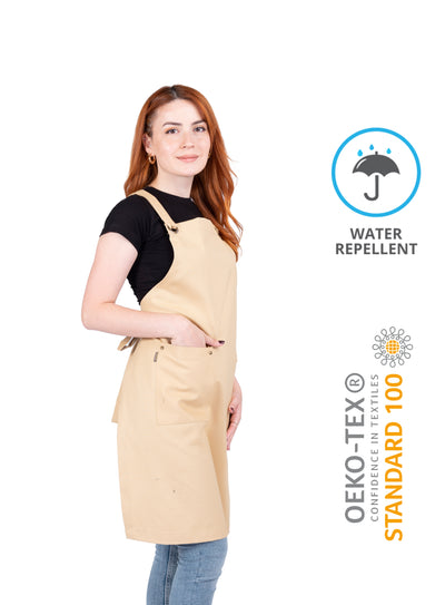 Mustard classic apron with cross-back ties on mannequin.