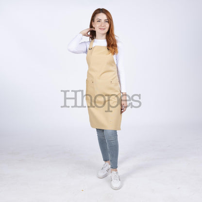 Detail view of Oeko-Tex certified tag on mustard apron.