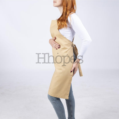 Apron laid flat, highlighting mustard color and stitching.