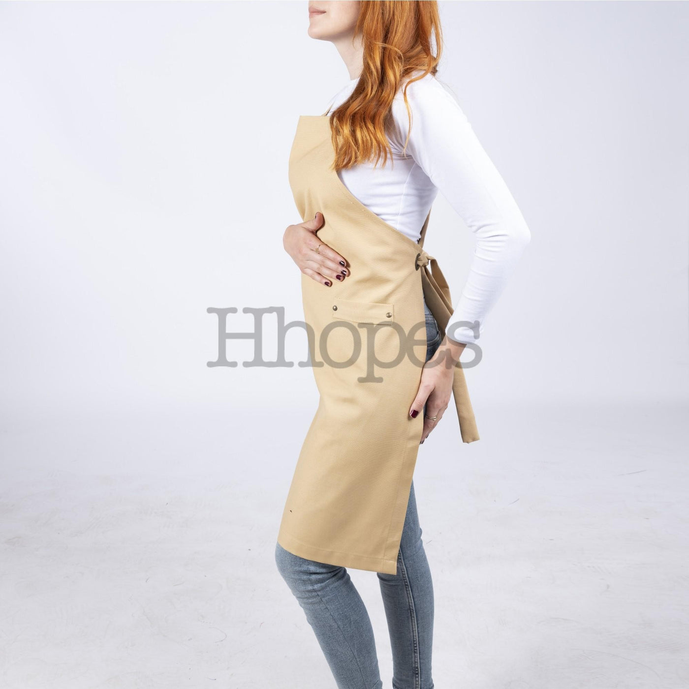 Apron laid flat, highlighting mustard color and stitching.