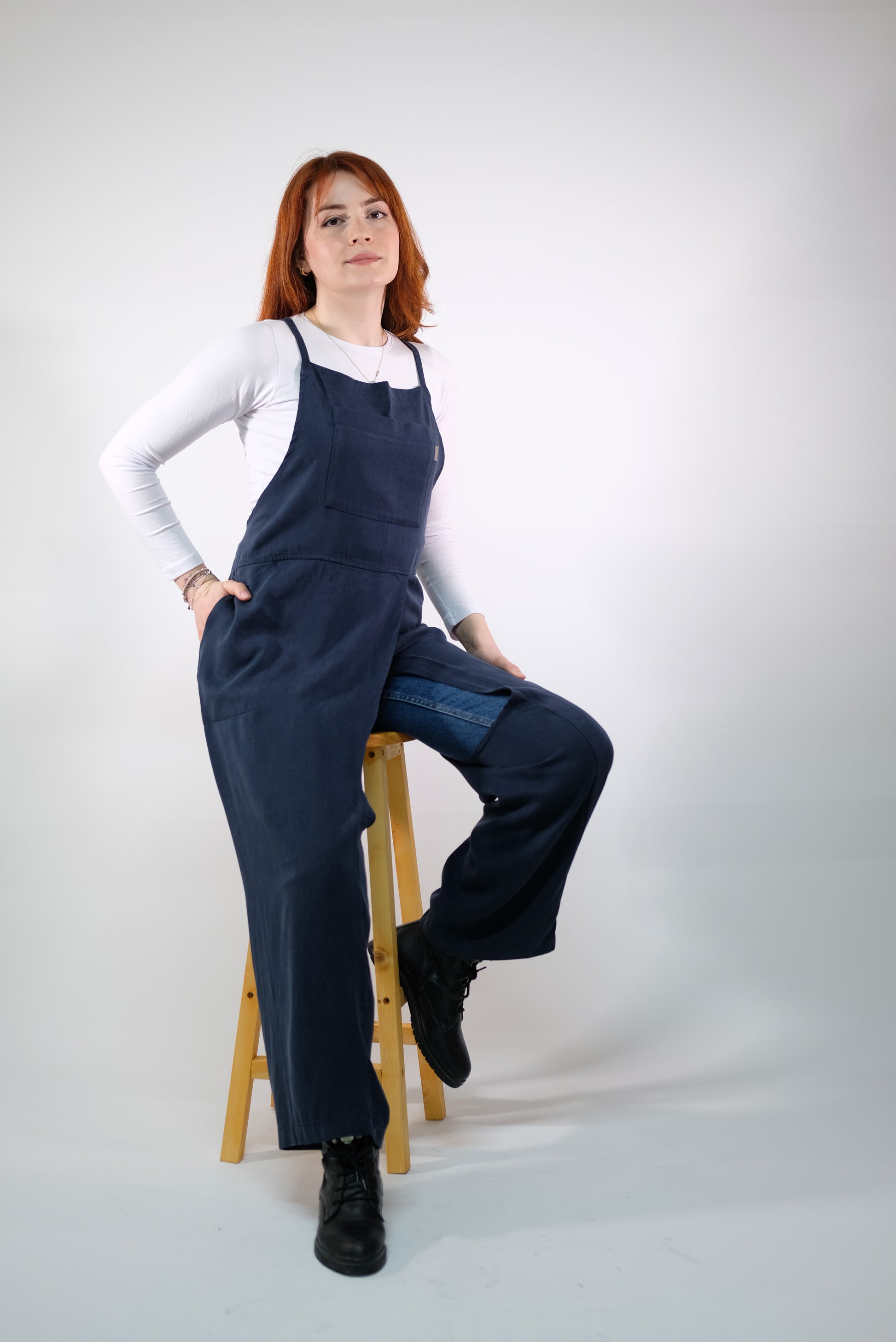 Navy backless apron displayed on mannequin for artists.