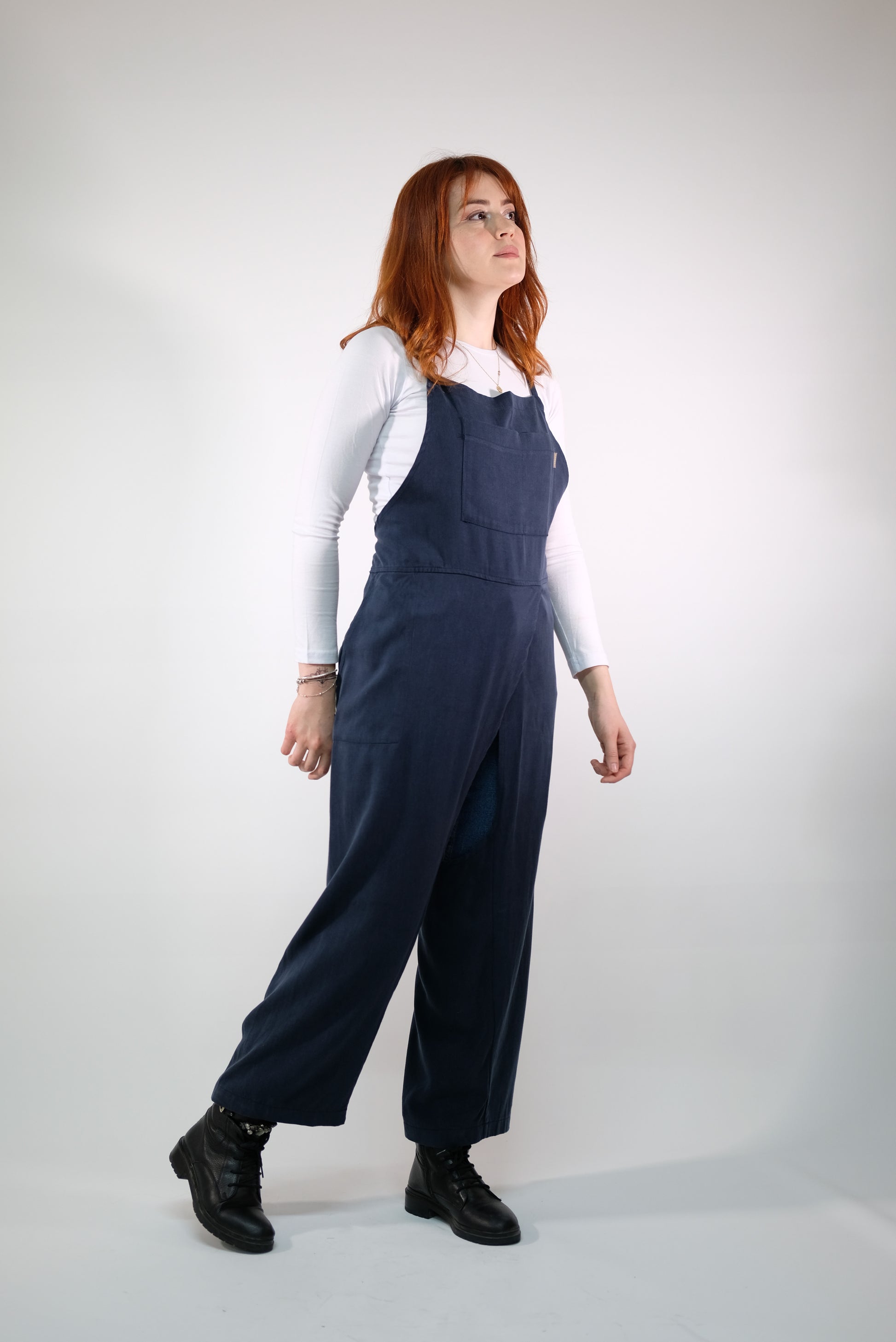 Navy apron tied at back, showing adjustable straps.