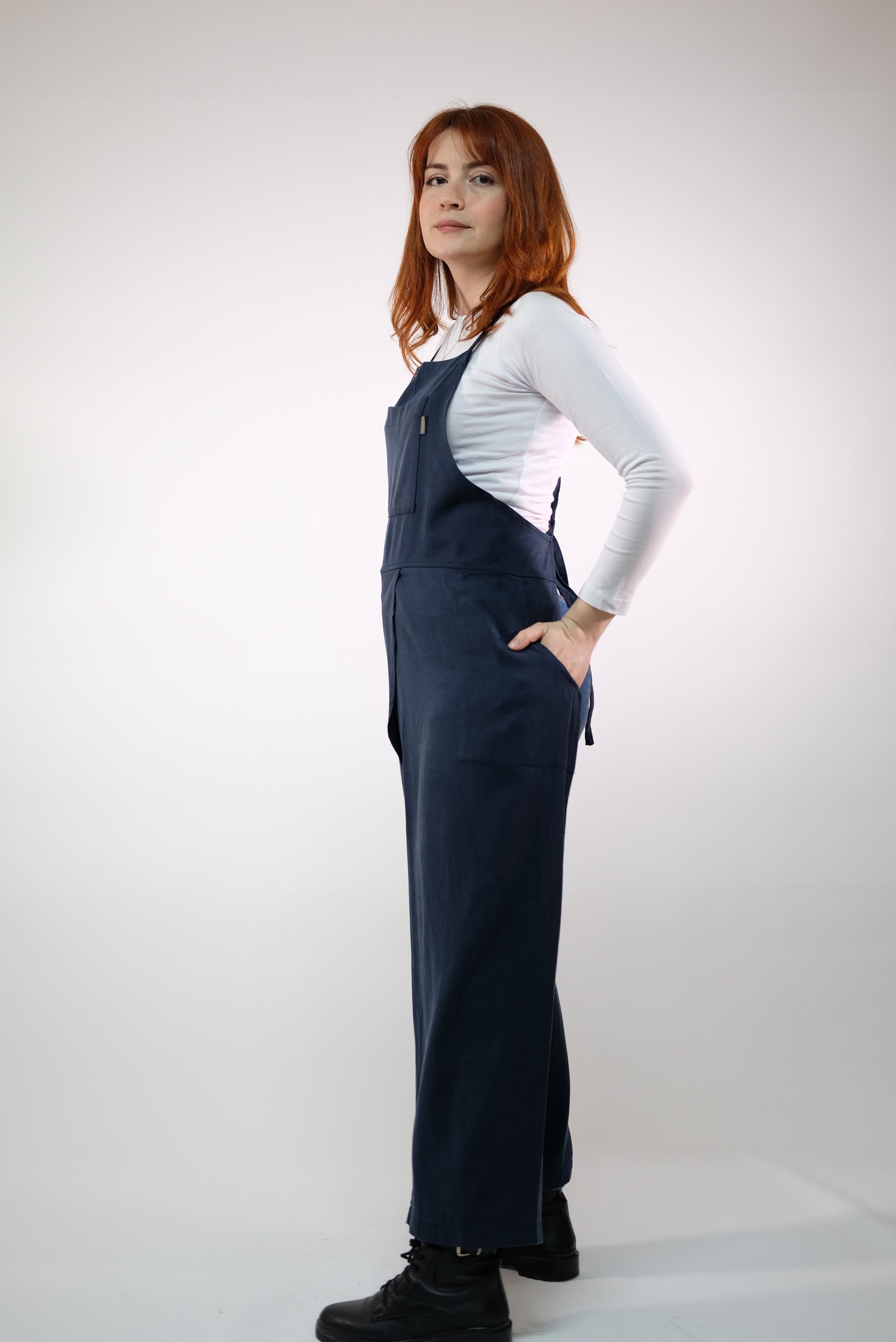 Apron laid flat, highlighting split-leg design and stitching.